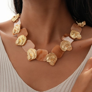 Chic gold metal and amber resin square pendant necklace worn by a fashion model