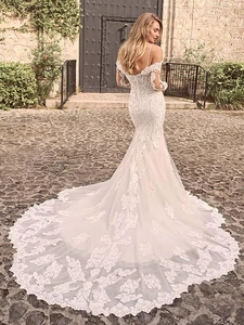 Exquisite floral lace mermaid wedding dress with a dramatic long train and off-shoulder back