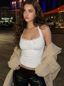 White lace halter top with bow detail and backless design for a stylish 2025 winter look