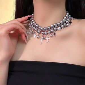 Detail view of multi-layer grey pearl choker with silver gothic cross pendants