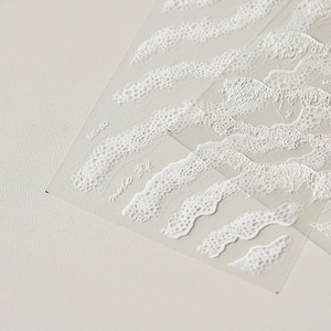 Dettaglio macro dell'adesivo per unghie bianco MS-80 con motivi a onde in rilievo 3D