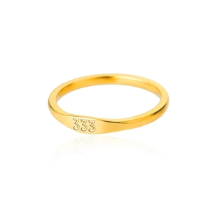 Macro shot of polished gold-plated stainless steel ring featuring 333 engraving