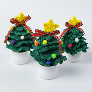 Detailed texture of handmade crochet mini Christmas tree in white ceramic pot
