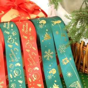 Christmas gold-stamped ribbons with reindeer and Santa patterns for festive gift wrapping