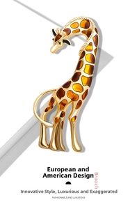 Detailed view of a gold-plated giraffe brooch with brown enamel dots and green gem eye