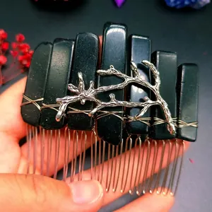 Detail view of gothic crystal hair comb with raw black minerals and silver branch accents