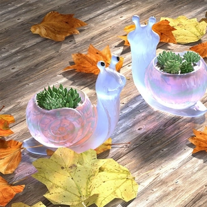 Iridescent snail succulent planter made of resin with LED light on wooden floor