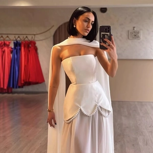 Elegant white strapless satin evening gown with shawl drape and pearl waist details