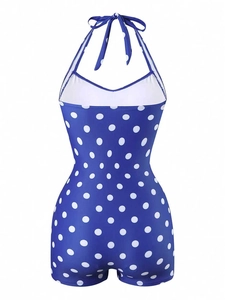 Detail of royal blue one-piece swimsuit with white polka dots and halter tie back
