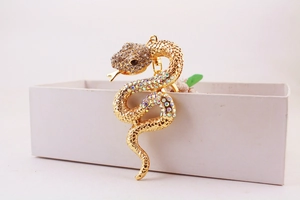 Detailed view of a golden snake keychain encrusted with colorful rhinestones and crystals