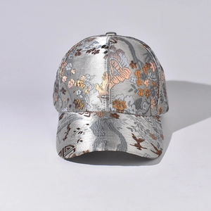 Detail of silver jacquard baseball cap with traditional floral and bird embroidery