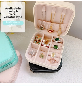 Close-up of portable jewelry box interior with necklace hooks and velvet ring slots