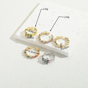 Minimalist 14K gold plated geometric rings with colorful zircon stones on stone background