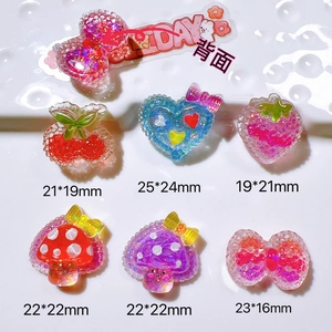 Macro view of colorful glitter resin DIY charms including strawberry and heart shapes