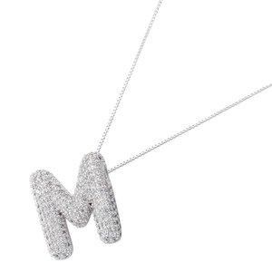 Close-up of balloon letter M pendant with shimmering pavé cubic zirconia on box chain