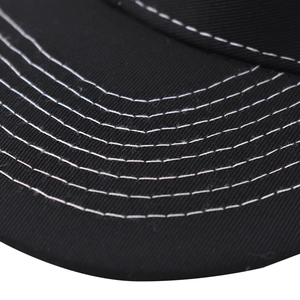 Detailed close-up of a black baseball cap brim with six rows of white contrast stitching