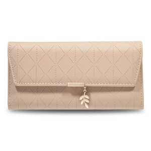 Macro detail of beige PU leather wallet featuring quilted texture and leaf charm