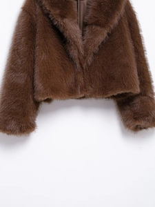 Close-up of deep brown faux fur jacket featuring a soft texture and notched lapel