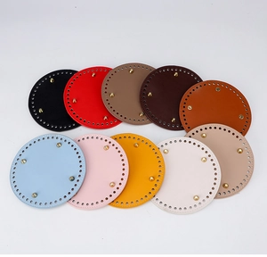 Macro view of multi-color circular PU leather bag bases with metal feet and pre-punched holes