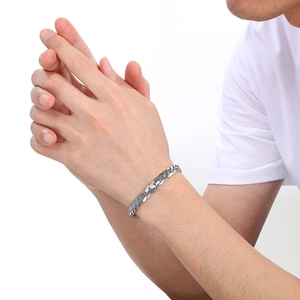Detail shot of men's silver flat Cuban chain bracelet in polished stainless steel