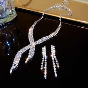 Detailed view of silver-tone teardrop rhinestone necklace and matching tassel earrings