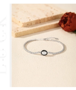 Detail of S925 silver tennis bracelet with black enamel oval charm and micro diamonds