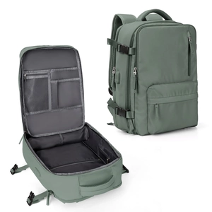Detail view of large green travel backpack showing USB port and multi-compartment interior