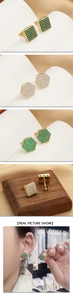 Detailed close-up of 18k gold geometric stud earrings with pave-set green cubic zirconia