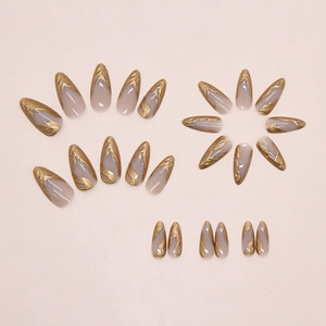 Close-up of long stiletto press-on nails with 3D liquid gold sunset flame patterns