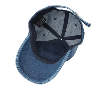 Inside view of blue distressed denim baseball cap showing 100% cotton lining and sweatband