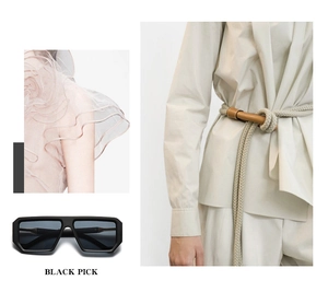 Flat top black square sunglasses with matte frame shown in a fashion styling context