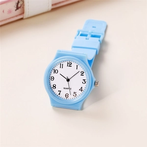 Close-up of a light blue minimalist quartz watch with black numerals and silicone strap