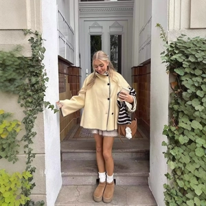 Women's chic beige wool coat with high collar, black stitching and silhouette design