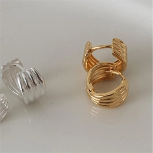 Minimalist wide ribbed silver and gold hoops with vintage wave texture in high quality metal