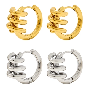 Triple-layered spiral hoop earrings in polished gold and silver finishes on white background