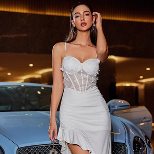Detail of corset bodice with floral appliques and sheer mesh on white party dress