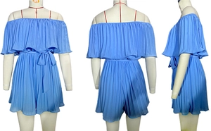 Detail of off-shoulder pleated romper in royal blue with elastic waist and ruffle trim