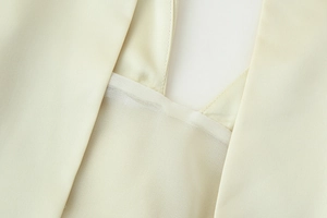 Detail of elegant cream halter neckline with high-quality textured satin fabric