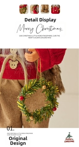 Detail of Santa figurine in red knit sweater with wooden buttons and miniature wreath