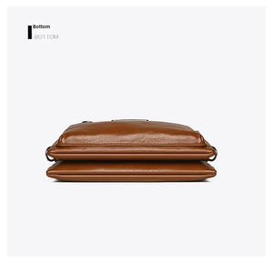 Bottom view of brown leather crossbody bag showing dual compartments and lychee texture