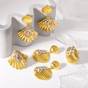 Golden shell and starfish stud earrings with pearls on decorative stand for beach style