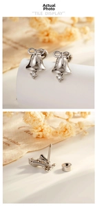 Detailed view of silver bow bell stud earrings with screw back and crystal drop
