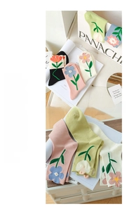 Detail of vibrant 3D flower embroidery on premium cotton mid-tube socks in soft pastel colors