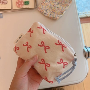 Mini floral cotton coin purse with red bow pattern and blue woven zipper pull strap
