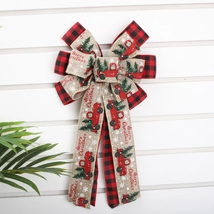 Large buffalo plaid Christmas bow with rustic truck design and Merry Christmas print