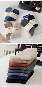 Close-up of ribbed knit crew socks in retro colors with professional paper band packaging