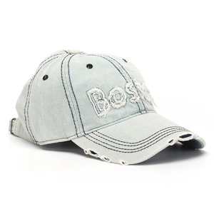 Detailed close-up of embroidered BOSTON letters on a vintage washed grey denim cap