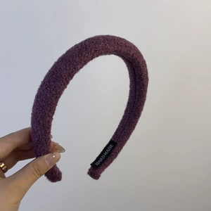 Macro detail of purple textured handmade sponge headband with high-top fleece design
