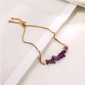 Detailed view of adjustable gold chain bracelet with irregular purple crystal stones