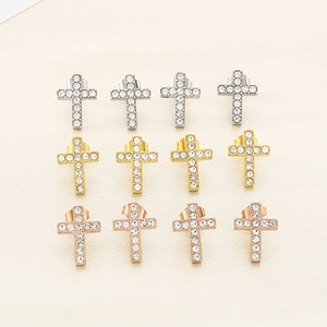 Detail of cross stud earrings in gold, silver, and rose gold with pavé cubic zirconia